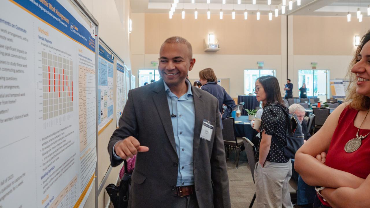 Researchers discussing a poster