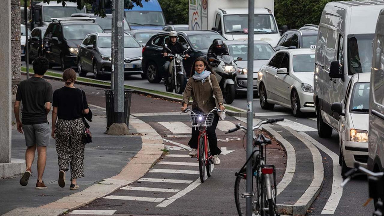 bike lane with pedestrians and car traffic