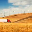 truck along hillside with wind turbines