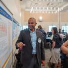 Researchers discussing a poster